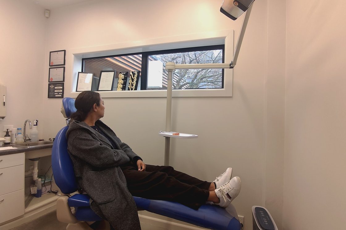 A patient in the chair in a dental treatment room, website design for clinics and practices in New Zealand